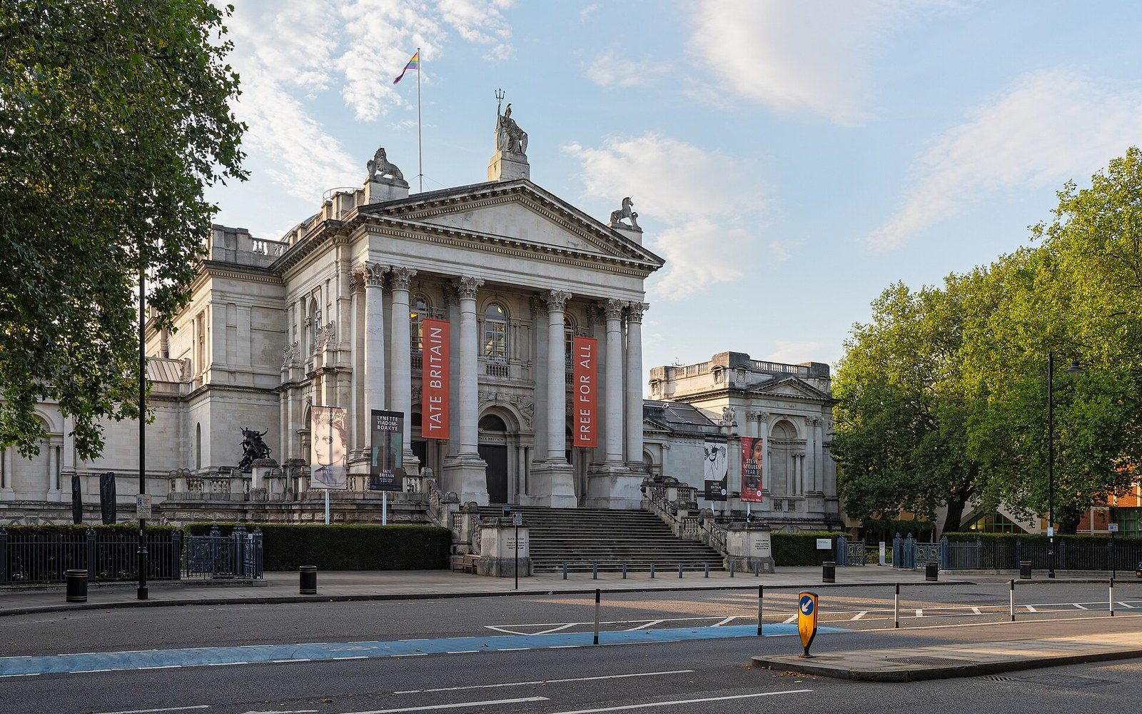 Tate Britain's neoclassical entrance with columned portico and steps facing an empty street