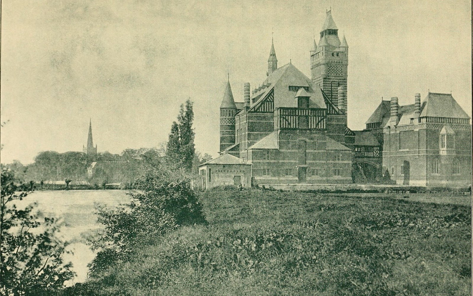 A turreted mansion with half-timbered gables stands beside a river, church spires visible in the distance